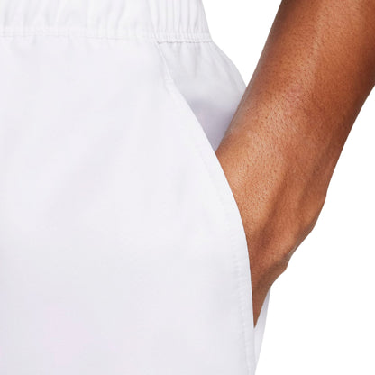 Close-up of a person wearing a white short with a visible arm.