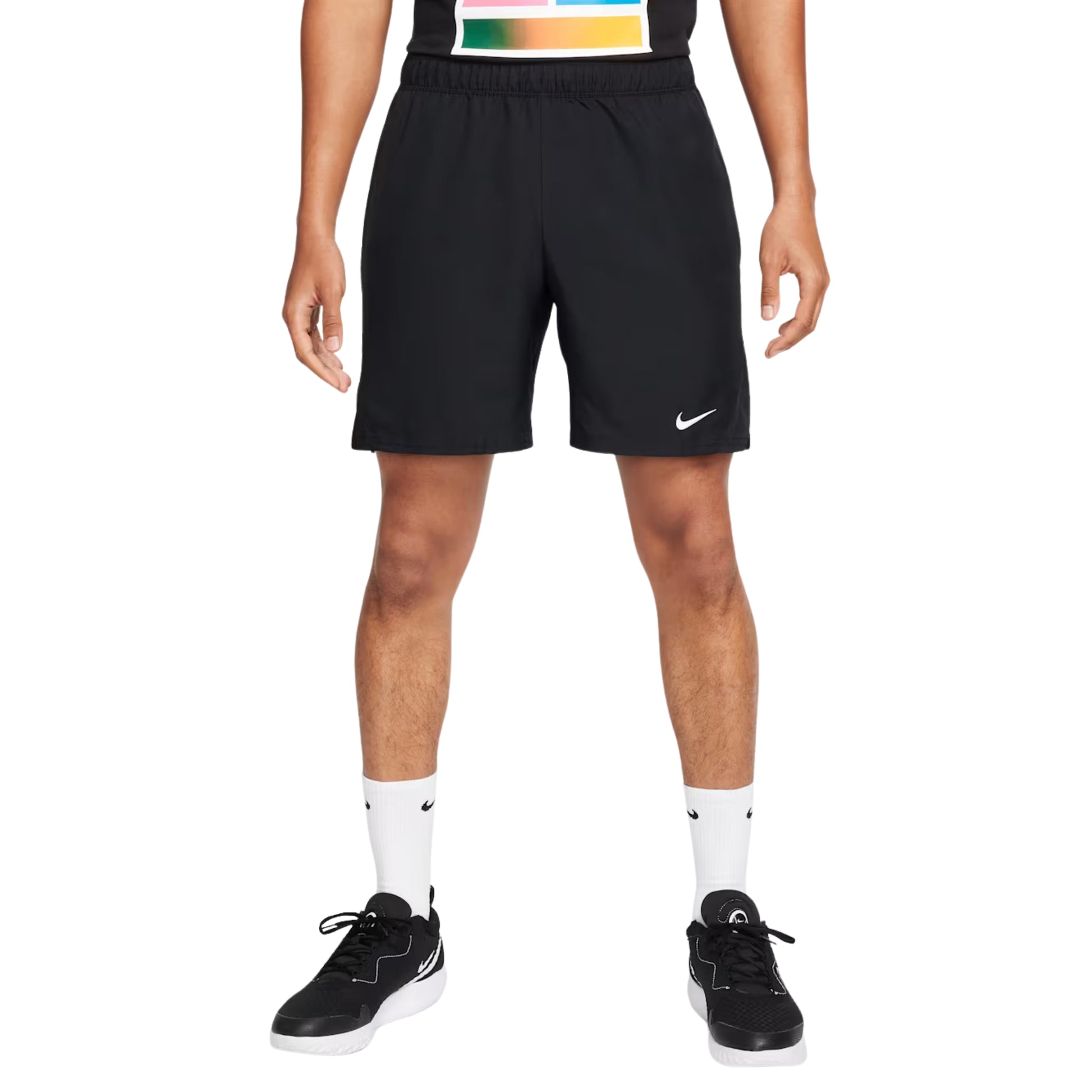 Person wearing black Nike shorts on a white background