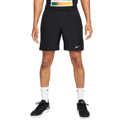 Person wearing black Nike shorts on a white background