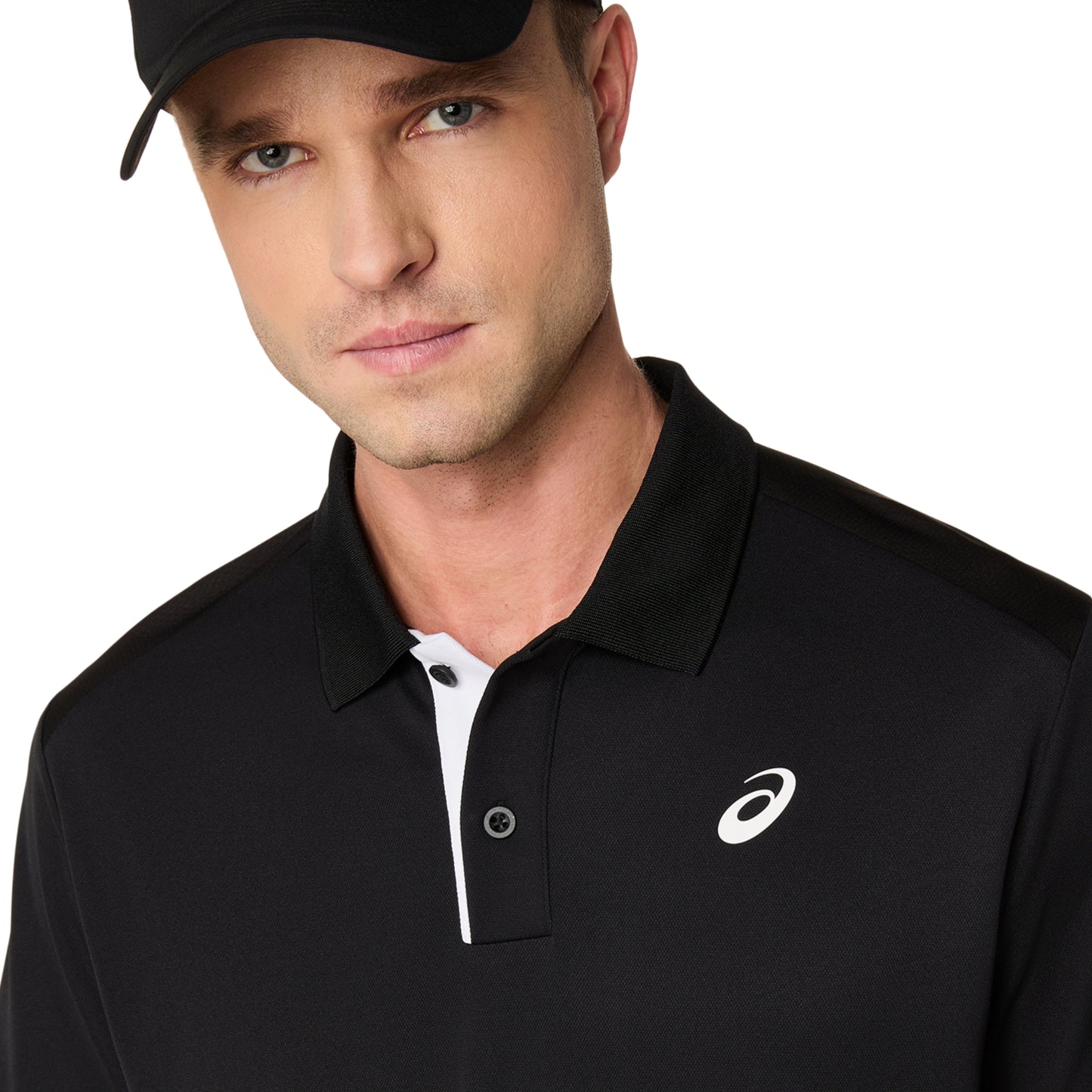Man wearing a black polo shirt white logo on shirt and on a white background 