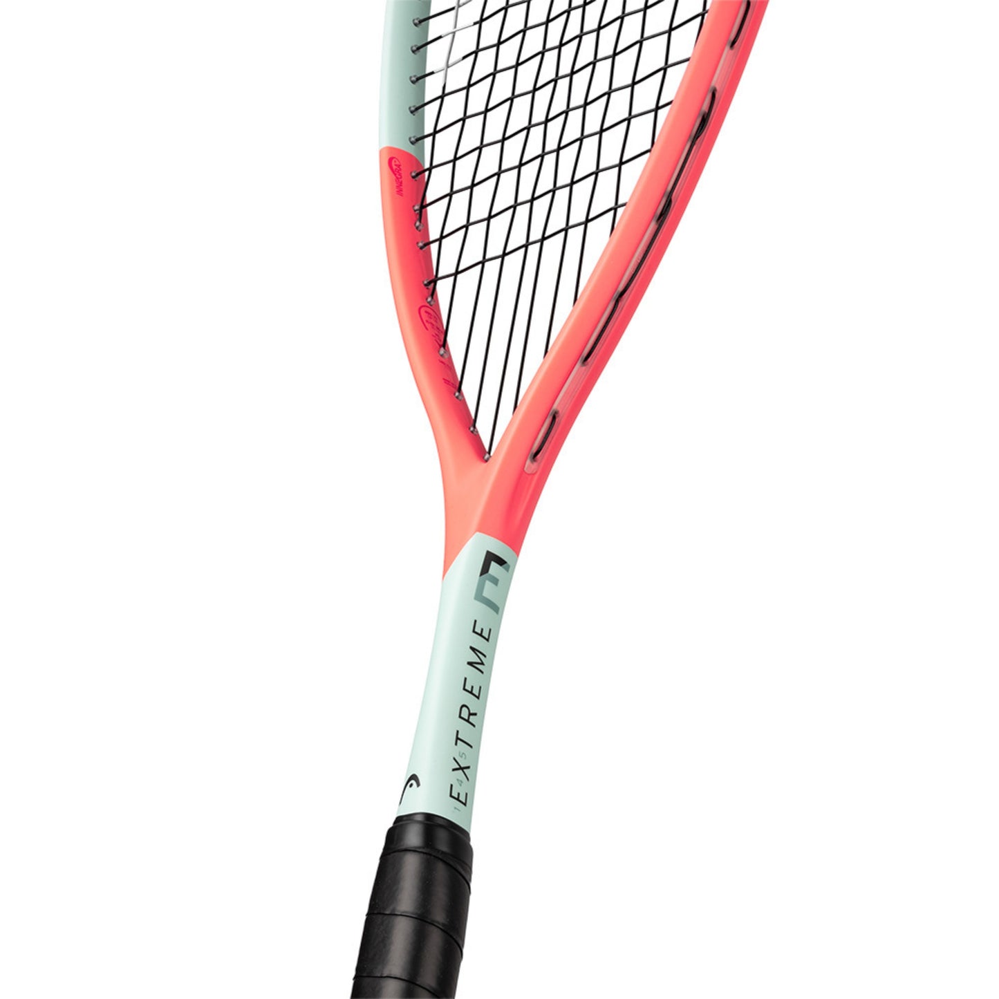 Close-up of a squash racket with 'EXTREME' branding on a white background