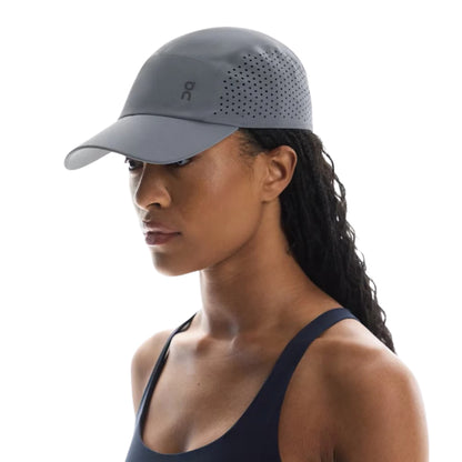 Woman wearing a grey On cap on a white background 
