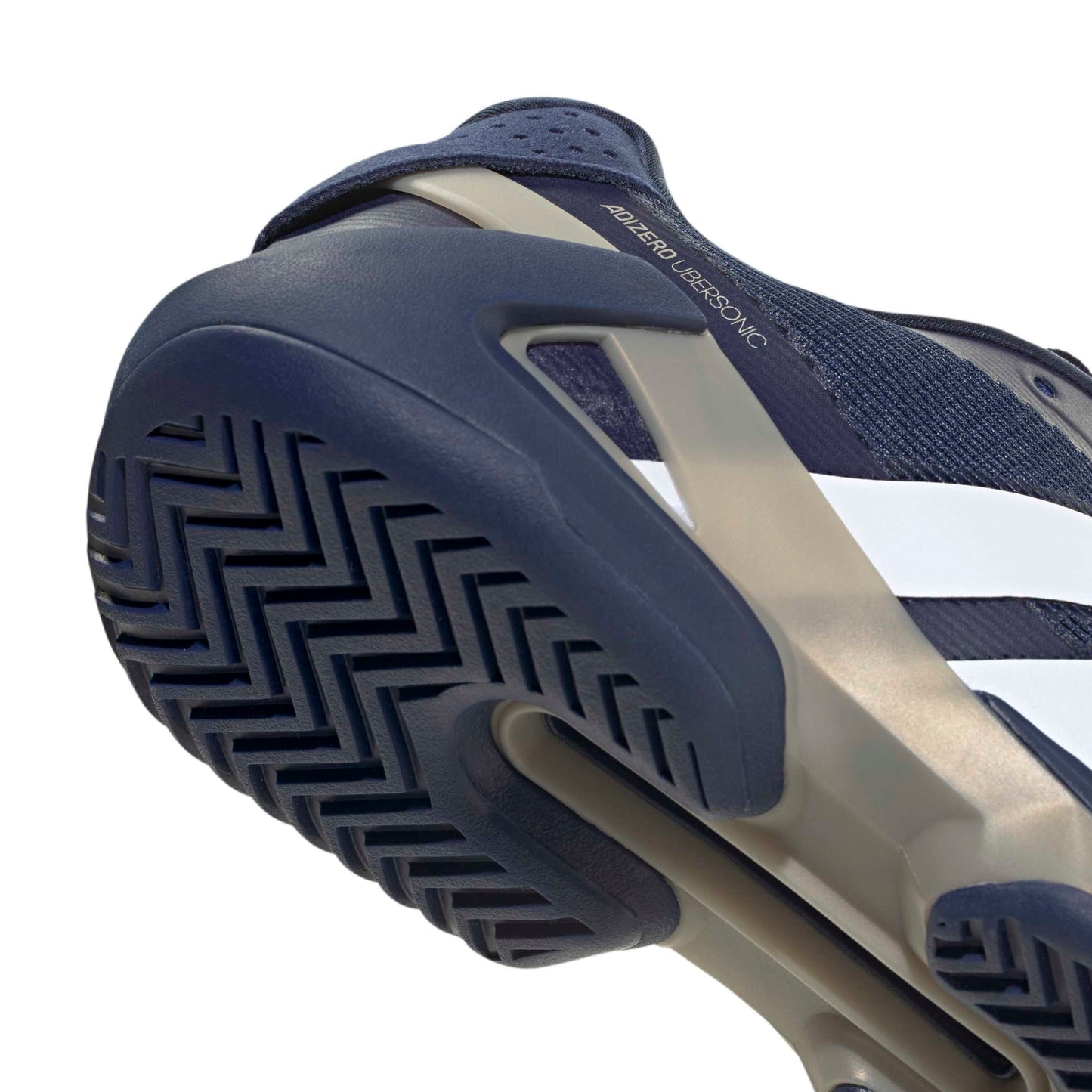 Close-up of a blue and beige adidas tennis shoe with textured sole on a white background