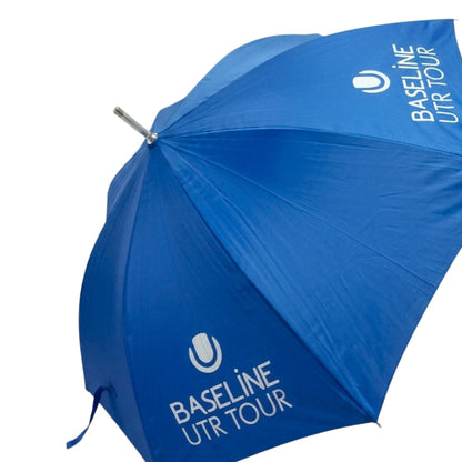 Blue umbrella with White Baseline UTR Tour logo