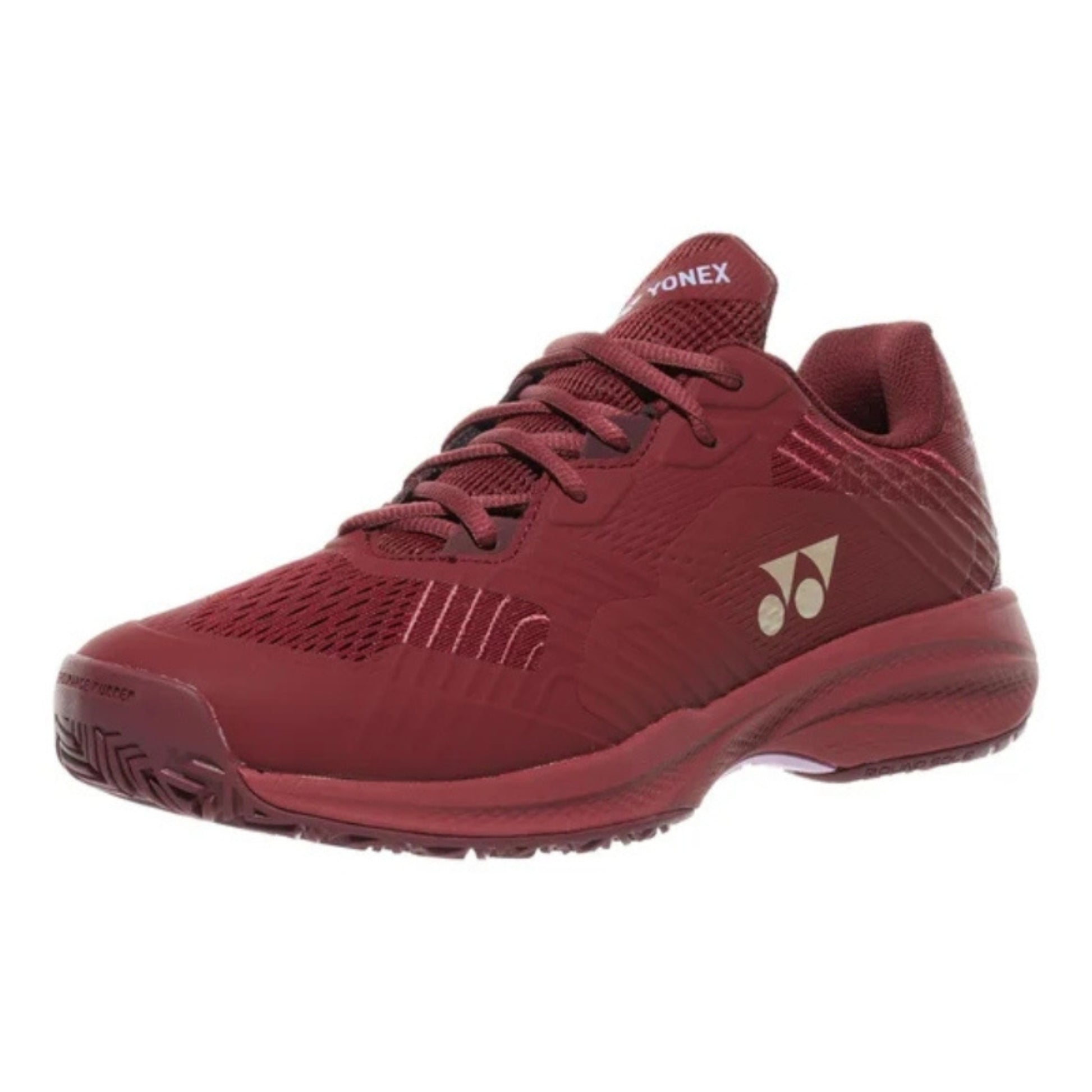 Red Yonex tennis shoe with brand logo on a white background