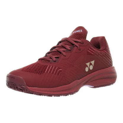 Red Yonex tennis shoe with brand logo on a white background