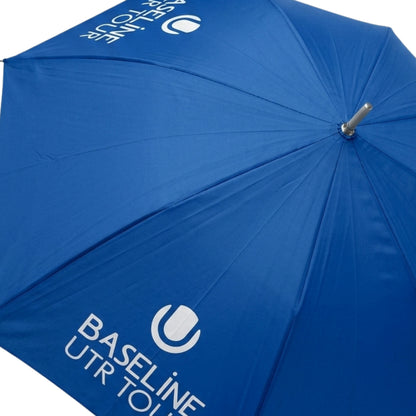 Blue umbrella with White Baseline UTR Tour logo